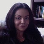 headshot of a smiling woman with long, straight black hair