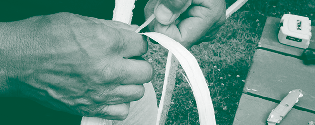close-up of a person working with a wood crafting material